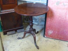 A George III circular mahogany tilt top tripod table, 58cm diameter, height 70cm