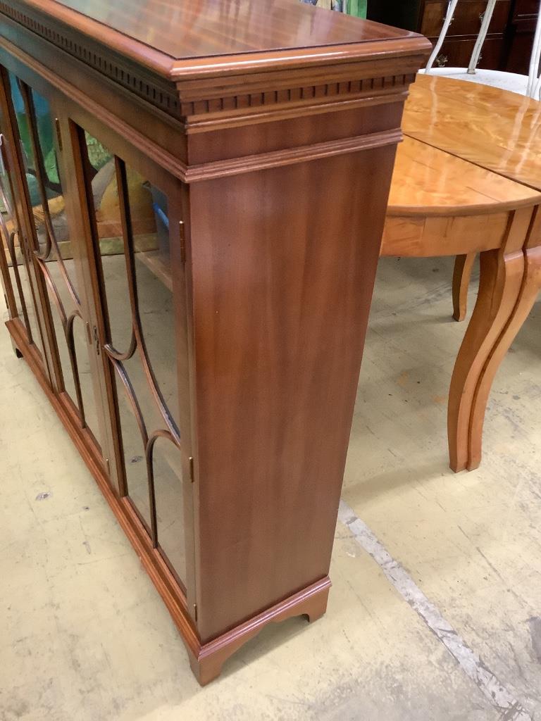 A reproduction mahogany three door bookcase, width 135cm depth 33cm height 116cm - Image 2 of 5