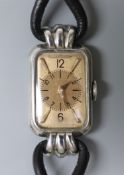 A lady's Art Deco stainless steel Jaeger LeCoultre rectangular dial wrist watch, on a fabric twin