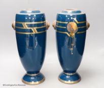 A pair of Art Deco blue glazed pottery vases, initialled PH, height 36cm