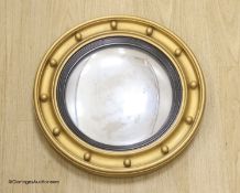 A circular gilt convex wall mirror, overall diameter 85cm