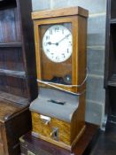 A vintage oak-cased electric wall factory time recorder clock, circa 1930,having circular painted