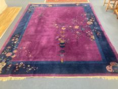 A large purple ground Chinese wool carpet, 342 x 276cm
