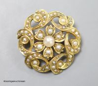 A late Victorian 15ct and seed pearl circular cluster pendant brooch, 25mm,gross weight 5.7 grams.