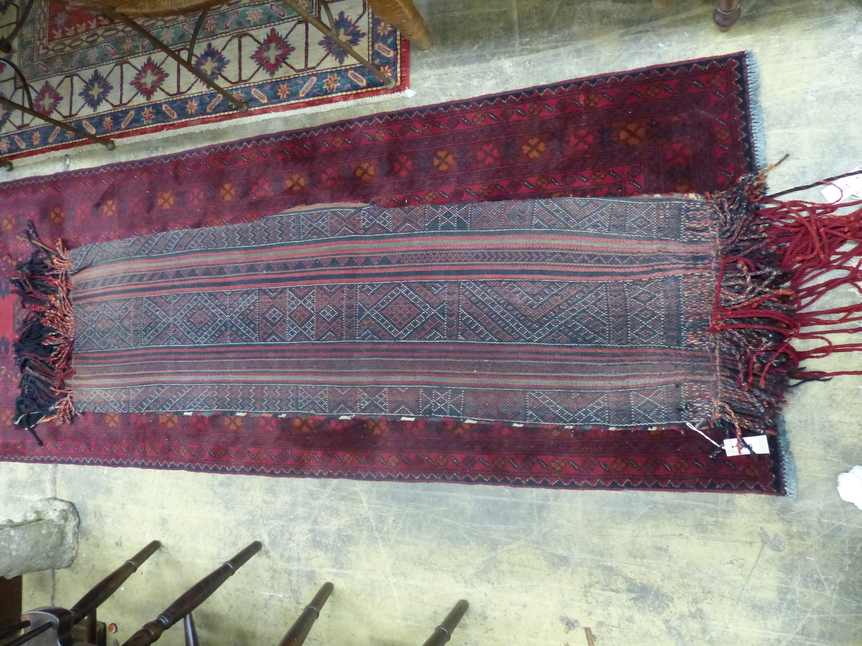 An Afghan saddle rug, 180 x 44cm - Image 2 of 2
