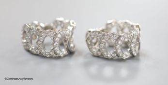 A modern pair of French Cartier white metal (18ct poincon mark) and diamond encrusted '7 C's'