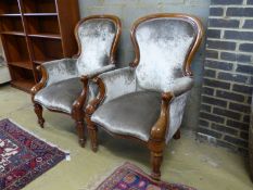 A pair of reproduction Victorian style mahogany spoonback armchairs, width 71cm depth 80cm height