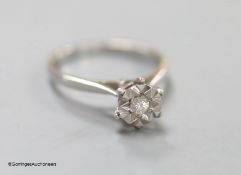 A modern 18ct white gold and illusion set solitaire diamond rig, size L/M, gross 2.4 grams.