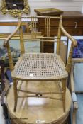 A Regency simulated bamboo caned seat elbow chair