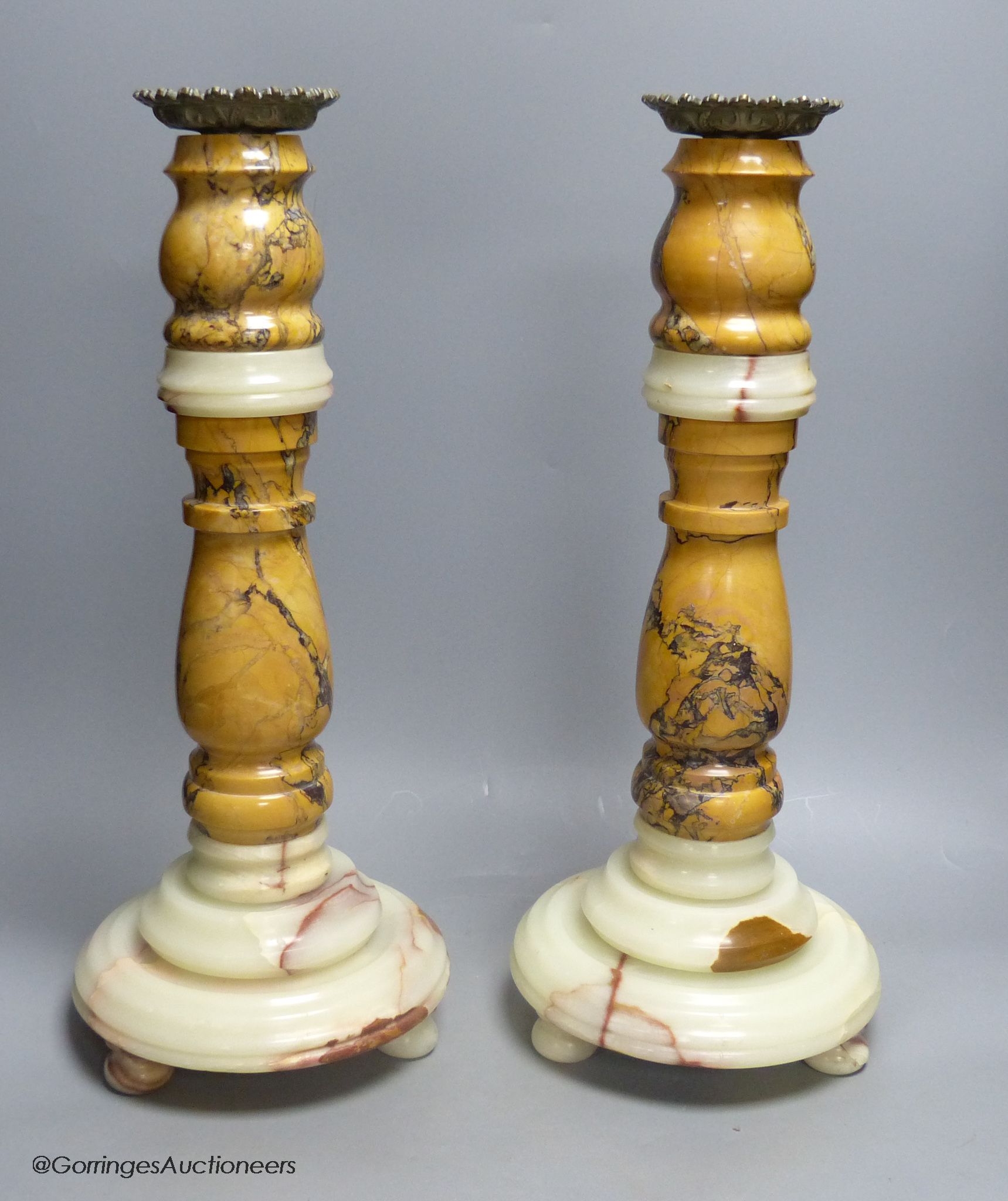 A large pair of 19th century variegated turned marble and onyx candlestands, height 46cm