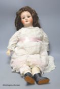 A Schonell Waldmeister bisque head doll, jointed body, vintage dress, 76cm tall.