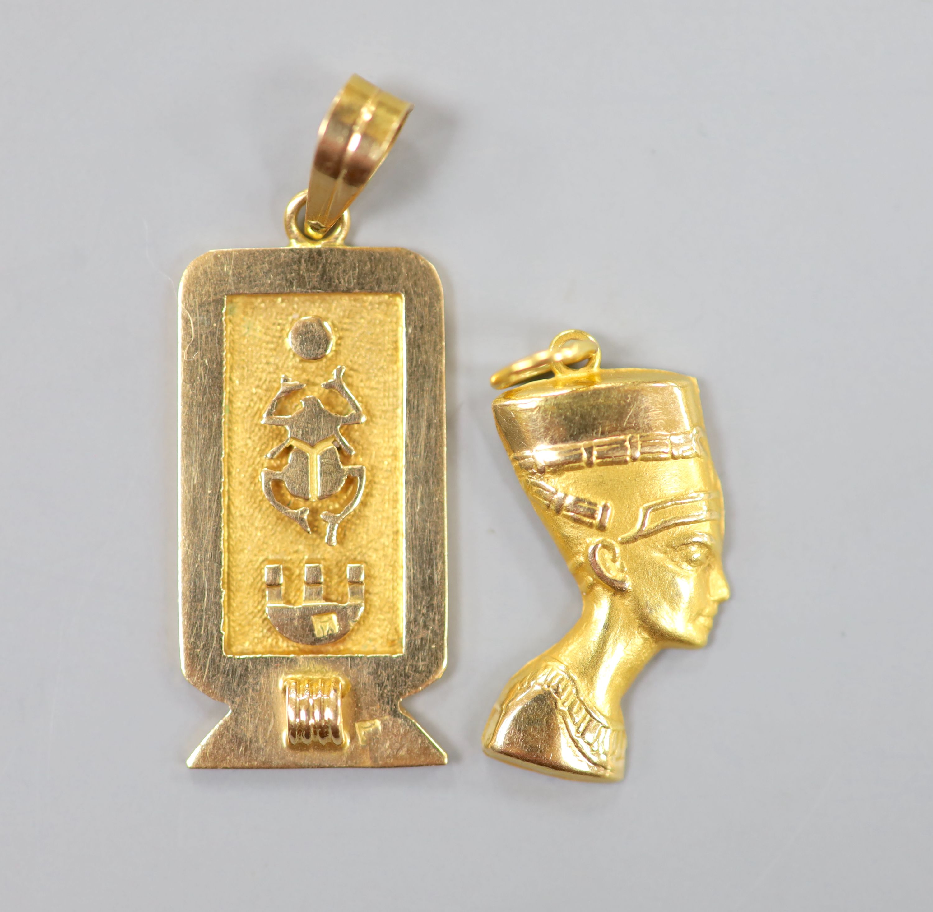 Two Egyptian gold charms (tested as 18ct), gross 6.3 grams.