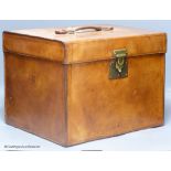 An early 20th century French brown hide travelling case, of cubic form, 33cm high, 33 x 36cm.