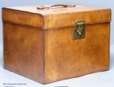 An early 20th century French brown hide travelling case, of cubic form, 33cm high, 33 x 36cm.