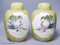 A pair of Chinese yellow ground vases and covers, height 30cm