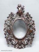 An 18th century Italian carved walnut oval picture frame, 41 x 30cm.