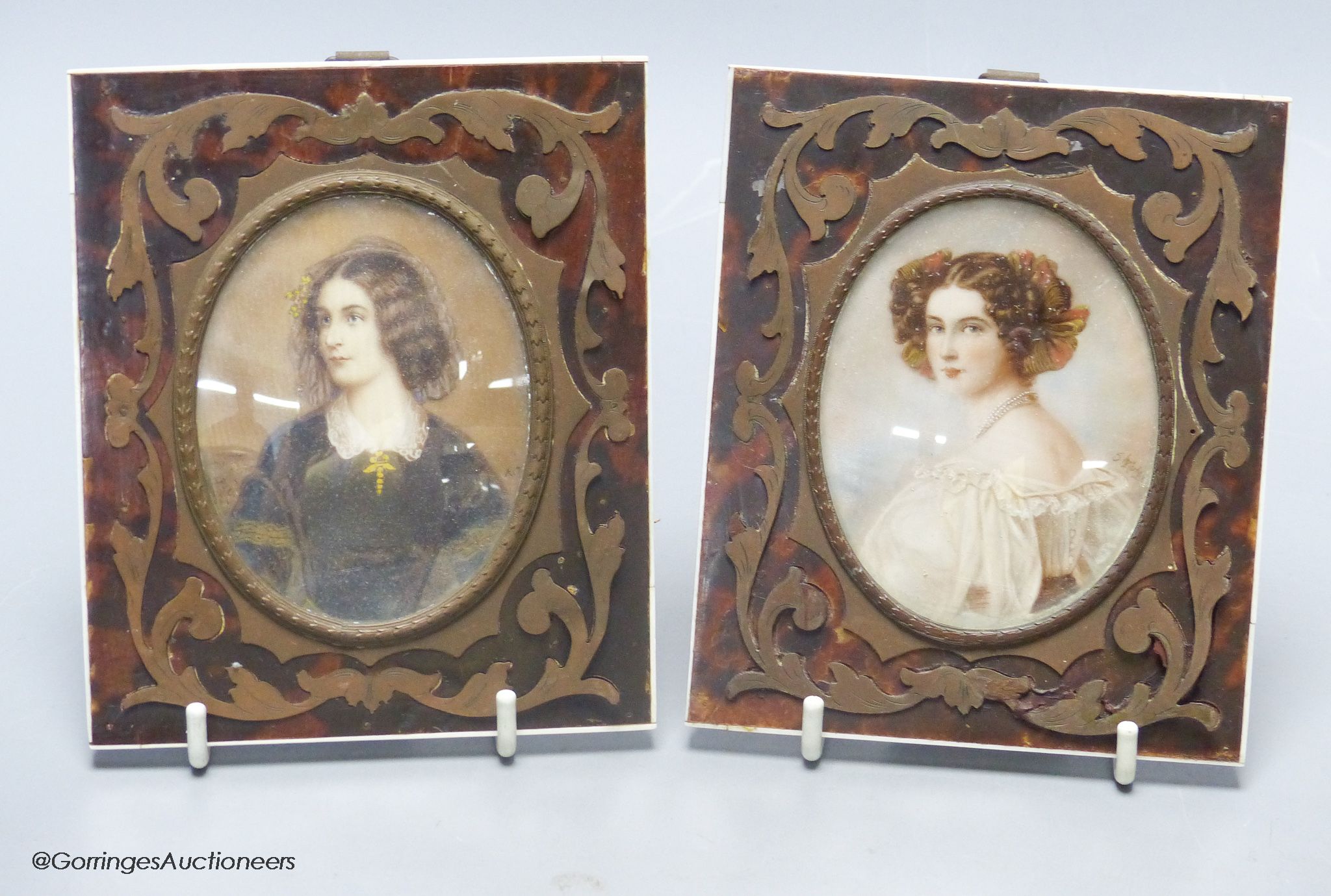 Two portrait miniatures on ivory, in boulle work frames, indistinctly signed.