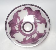 An amethyst overlaid glass fruit bowl, decorated with horses, height 34cm