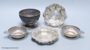 A silver pedestal bowl with cast foliate rim, a pair of pierced and embossed silver shaped circular