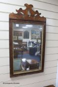 An 18th century mahogany mirror with fret carved cresting