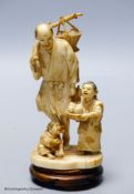 A Japanese ivory okimono of a peach seller