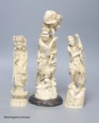 Three antique Japanese carved ivory okimono, tallest 32cm including wood stand