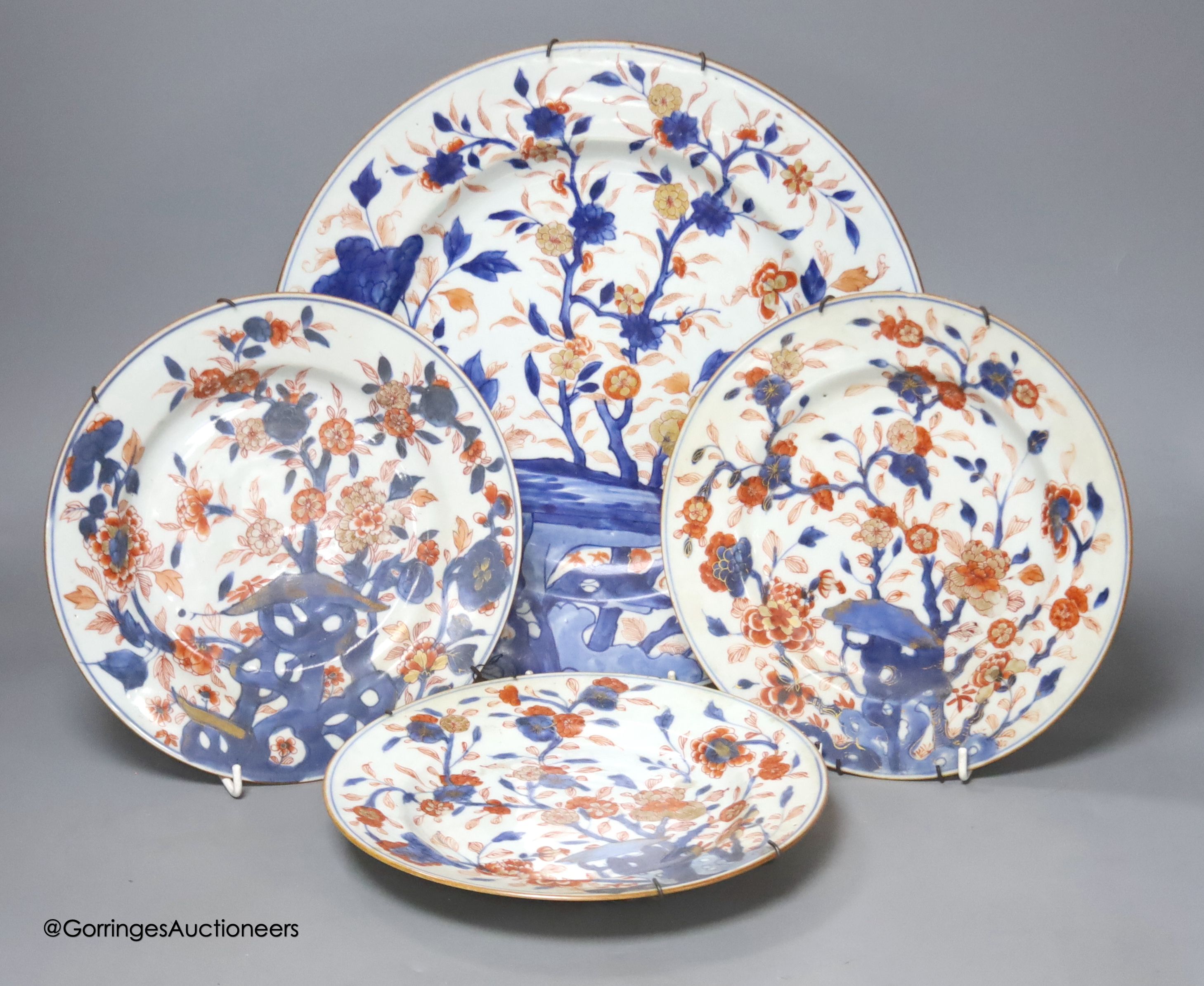 Three Japanese Imari plates together with a larger dish, 18th century, diameter 32cm