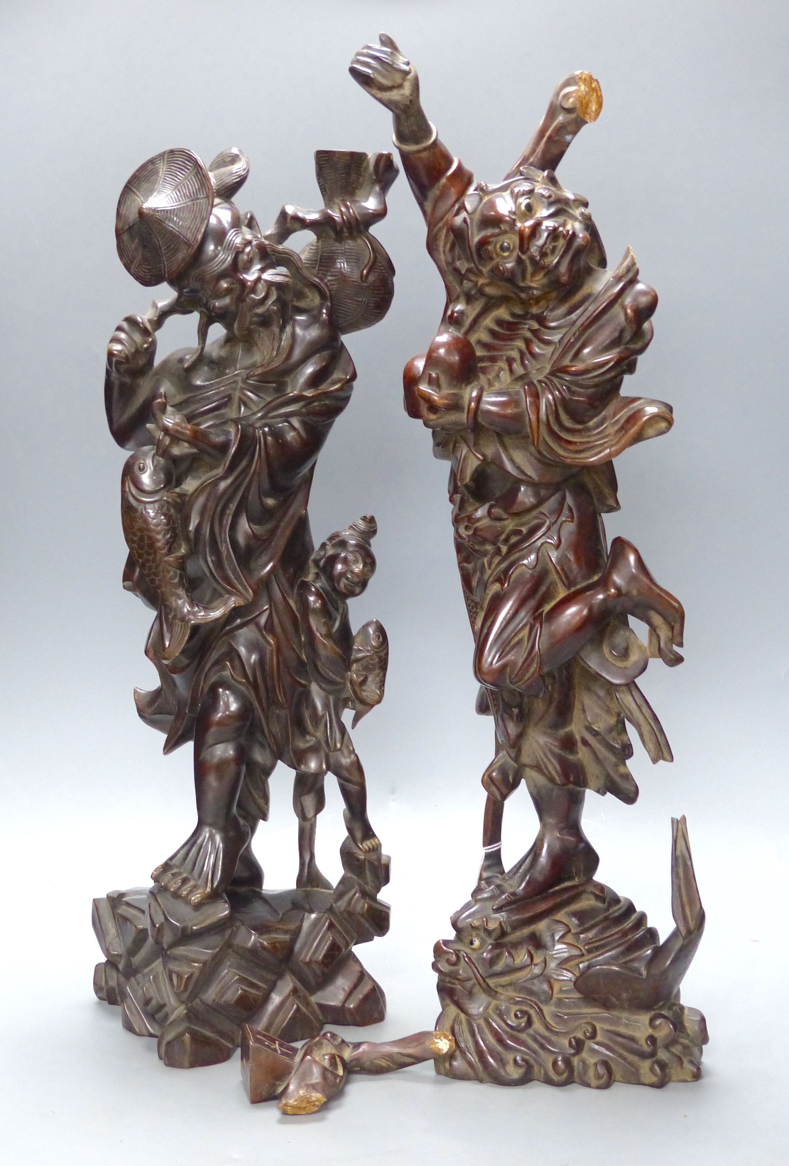 Two early 20th century Chinese hardwood figures of a demon and a fisherman, tallest 61cm