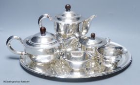 An early 20th century German planished 830s white metal six piece tea and coffee service comprising