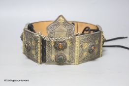 An unusual Eastern white metal and jewelled leather belt, length 80cm