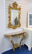 A 19th century rococo revival giltwood console table, 95cm wide, 86.5cm high and a similar later