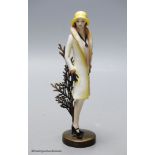 An Albany Worceter Art Deco style bronze and porcelain model of a young woman