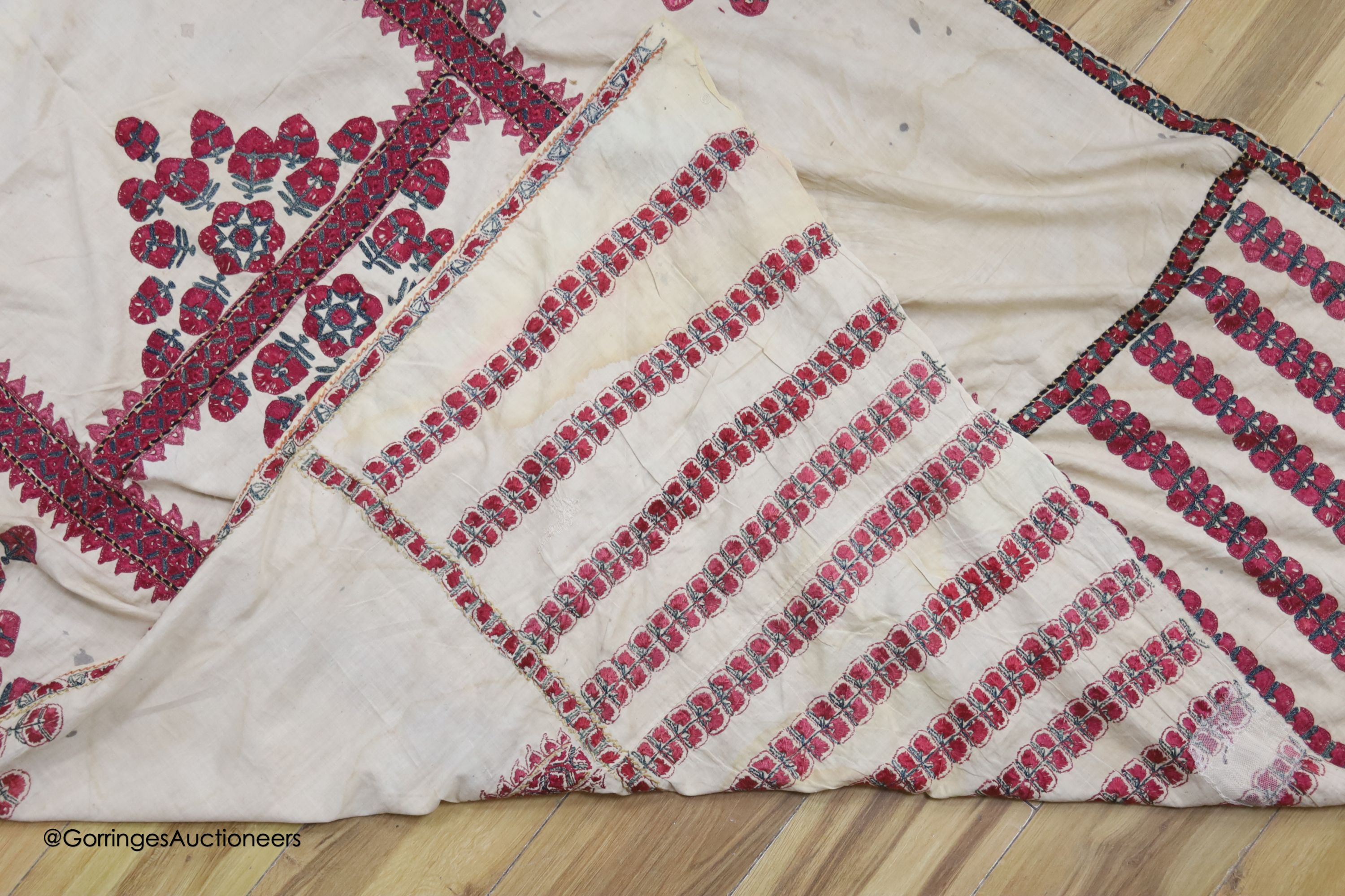 A silk embroidered Suzani, embroidered with cherry red flower heads with green stems and leaves in - Image 6 of 6