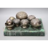 A collection of Malay Straits white metal circular betel nut boxes ('Chimbul'),comprising seven