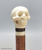 A malacca and ivory skull handled walking stick