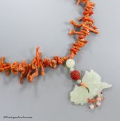 A jagged coral bead necklace, with jade pendant, carved as a fish, necklace approx. 88cm, fish