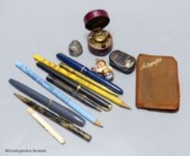 A collection of pens, commemorative pencils and mixed items