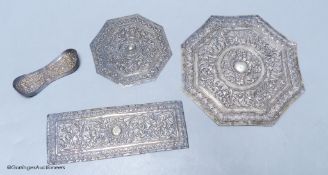 Three Malay Straits white metal 'buntal' or pillow ends,two of octagonal form, W 15.5cm and 10cm