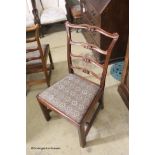 A set of six George III style mahogany pierced ladderback dining chairs
