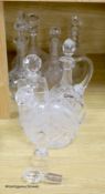 A collection of clear cut glass decanters