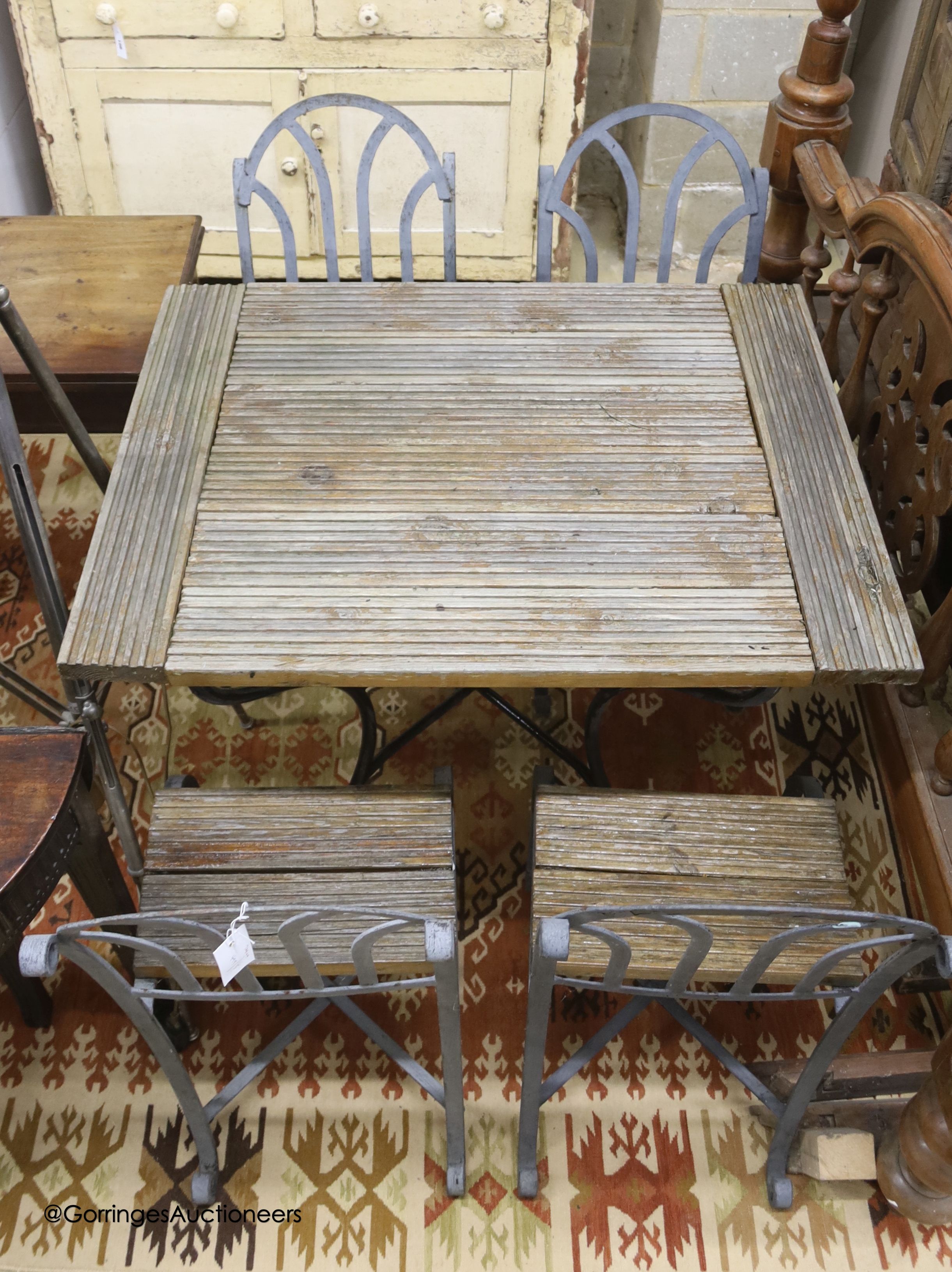 A French slatted wood wrought iron garden table, width 72cm, depth 94cm, height 78cm and four