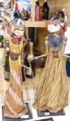 Two Indonesian stick puppets and a book relating to stick puppets, tallest 70cm