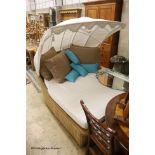 A Bevan Funnel All Weather rattan double garden daybed with metal canopy, mattress and cushions,