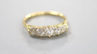 An early 20th century 18ct and graduated five stone diamond set half hoop ring, with diamond chip