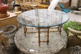 A circular faux bamboo framed glass topped coffee table, diameter 101cm, height 42cm