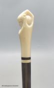 A rosewood and ivory handled walking stick in the form of a hand holding a ball
