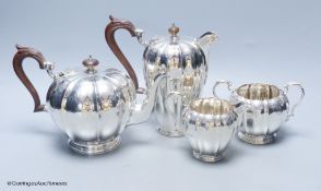 A George V engraved fluted silver four piece silver tea set by Adie Bros, London, 1923,27,28,gross