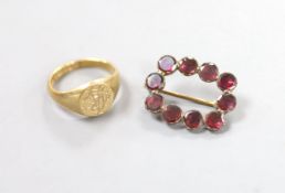 A George V 9ct gold signet ring, size H, 3.6 grams and a Victorian garnet set brooch.