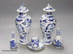 A pair of lidded Chinese blue and white vases, c.1900, Kangxi marks, 23cm high, together with two