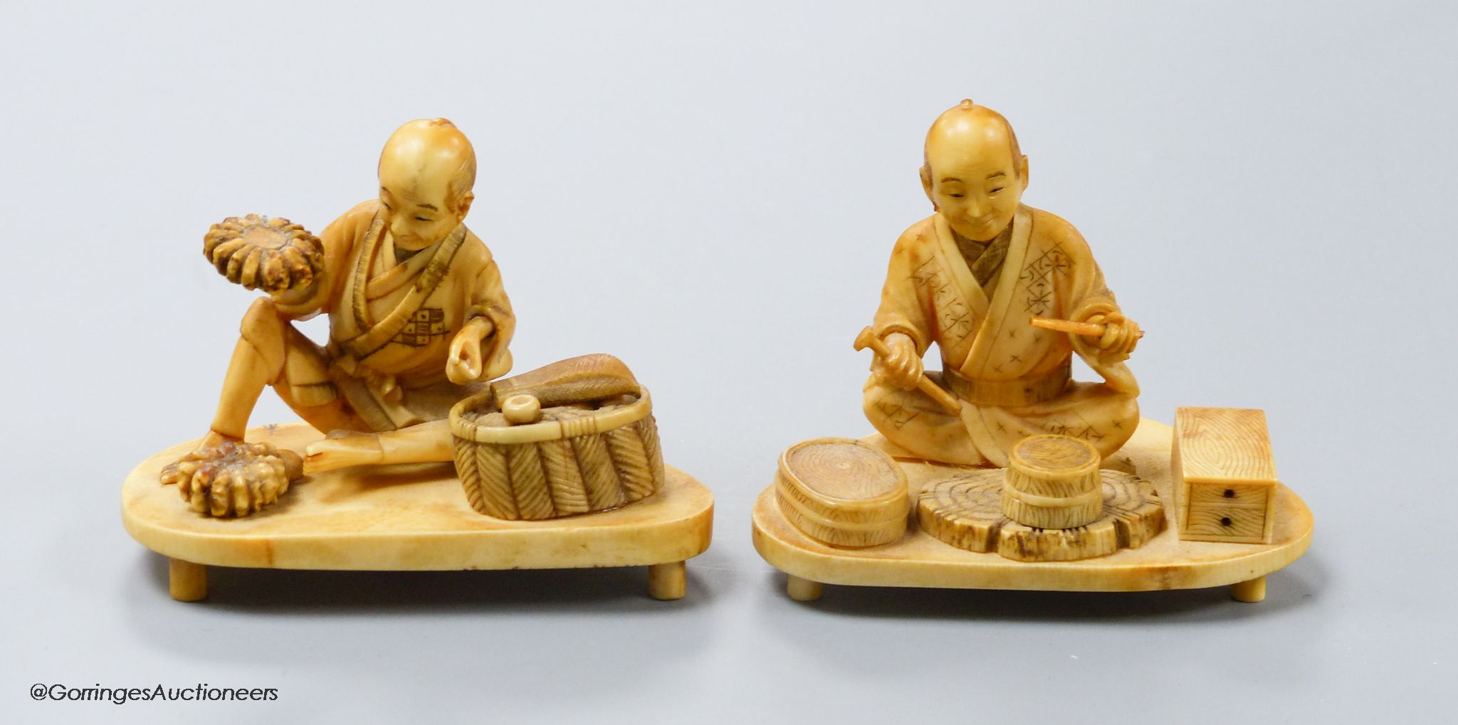 Two Japanese ivory okimono of a craftsman